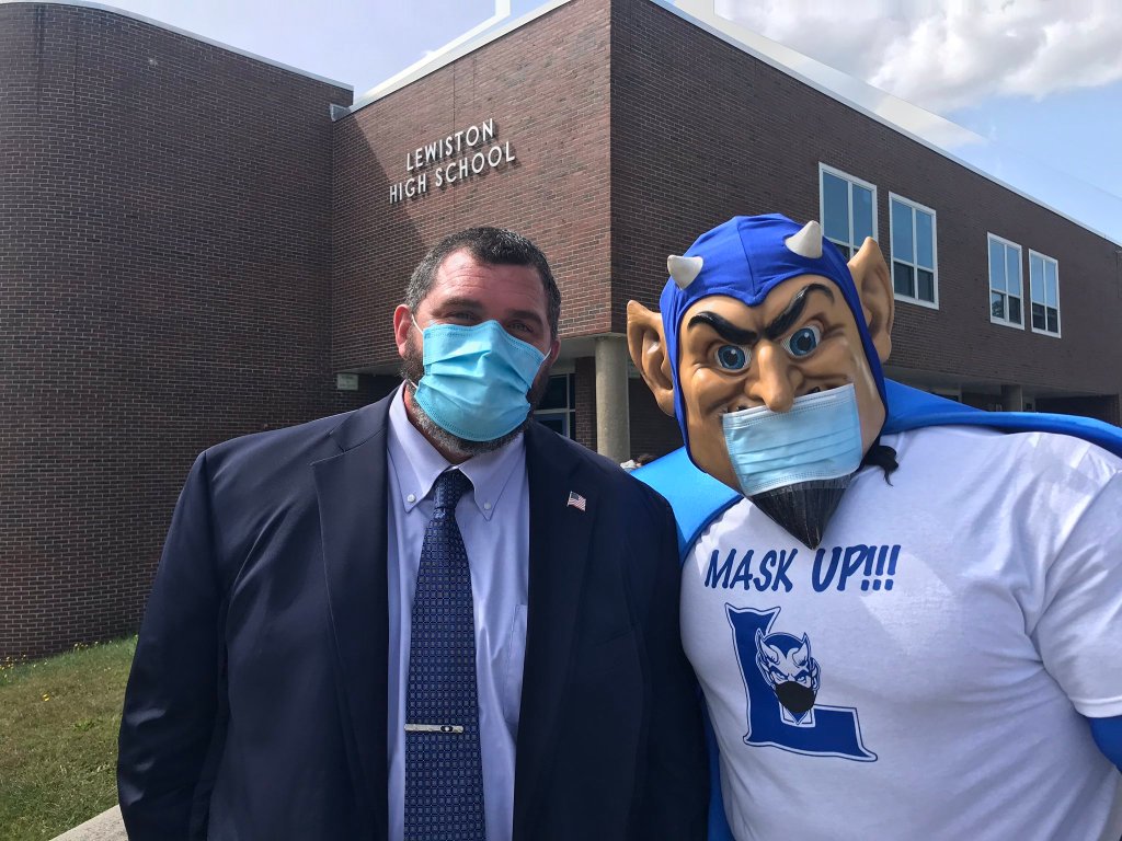 Superintendent and mascot pictured wearing masks outside Lewiston High School