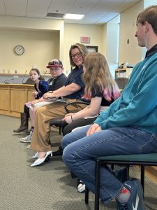 Laura Cyr leading students in a mock legislative hearing.