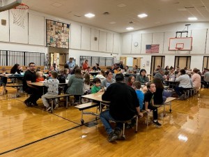 math night, families and students sitting at tables