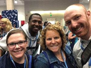 four people pose for picture