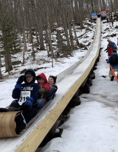 students on toboggan