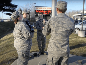 students raising flag