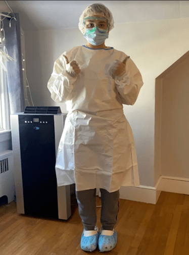 Nursing Student Demonstrating how to put on PPE