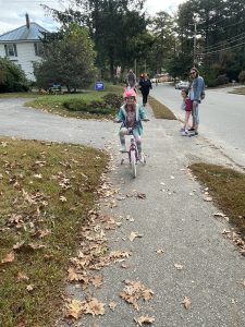Child biking on the sidewalk