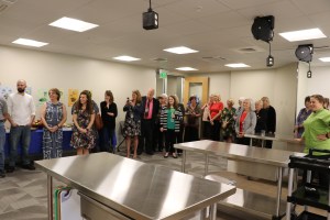 People gather in the kitchen for the kitchen dedication.