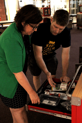 Course Instructor Keith Kelley and EMMC President Lisa Larson looking through a STEAMRoller cart included with the course.