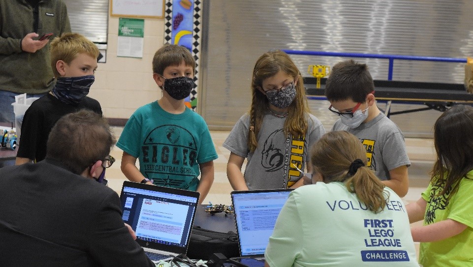 Members of the Leeds Central School team present their projects to judges Jon Graham (Maine Department of Education) and Dr. Laura Gurney (Husson University).