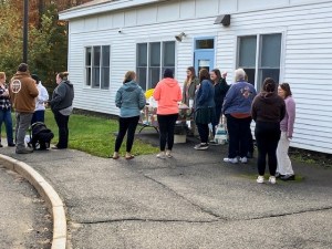 people gathered talking to eachother outside the school