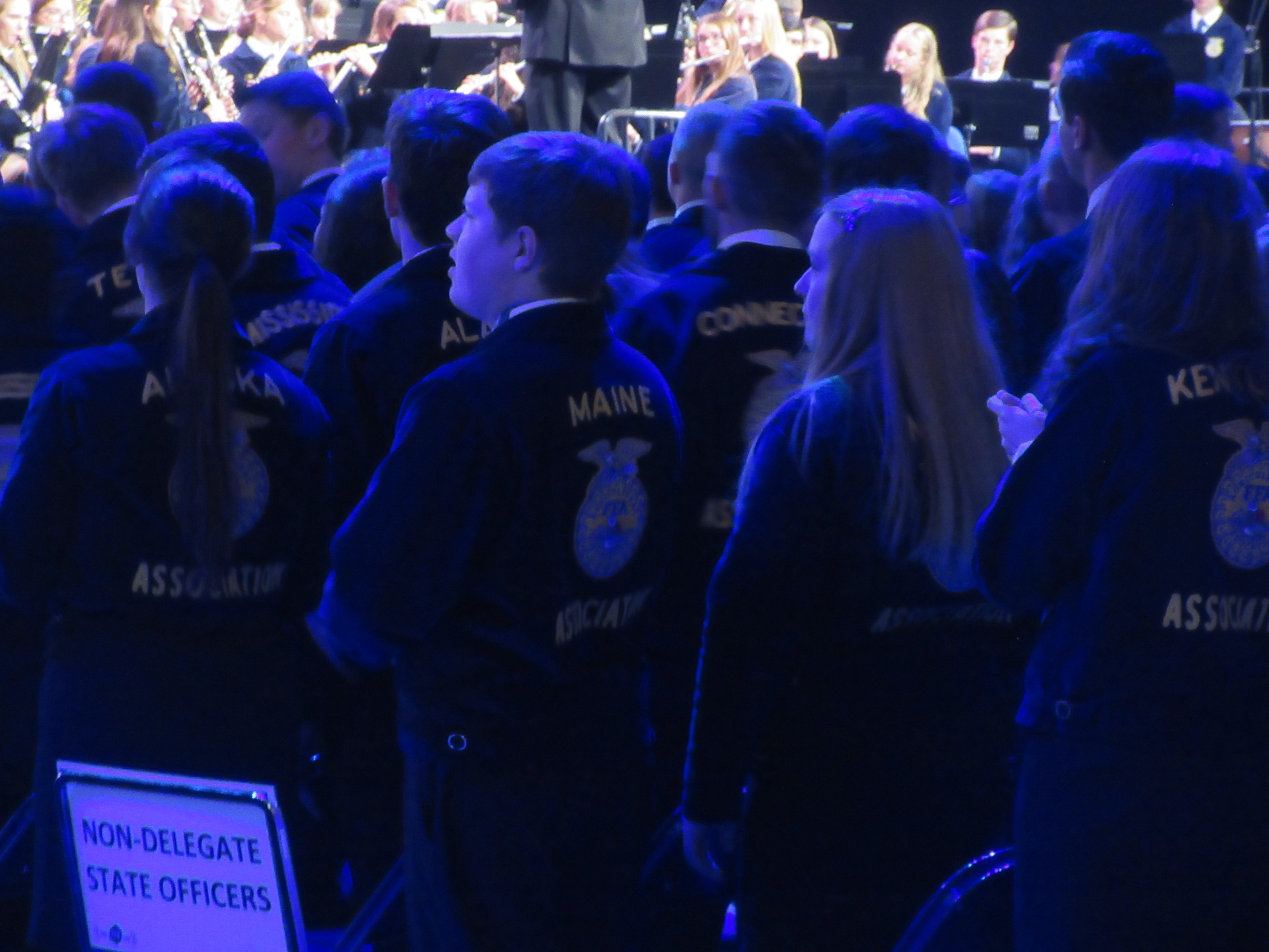 Maine FFA State Secretary-Treasurer Ava Cameron presents the Maine Flag at the Opening Session.