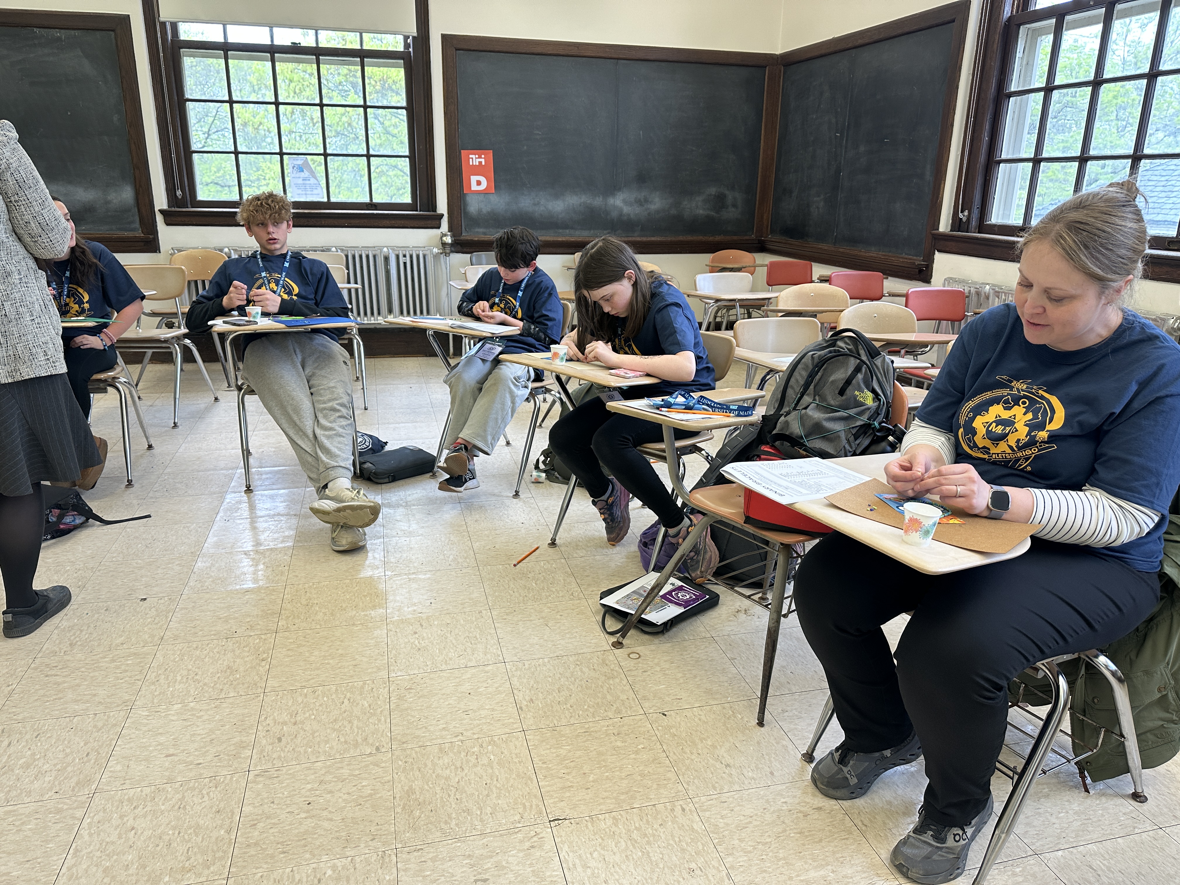 Students from Lenard Middle School in Old Town are working on Binary Bracelets. They are creating bracelets with their name written in binary code.
