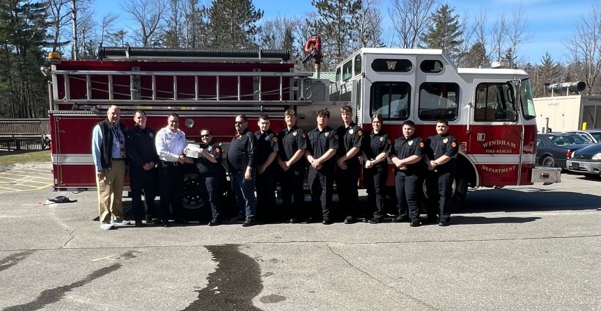 Firefighters standing in front of a fire truck