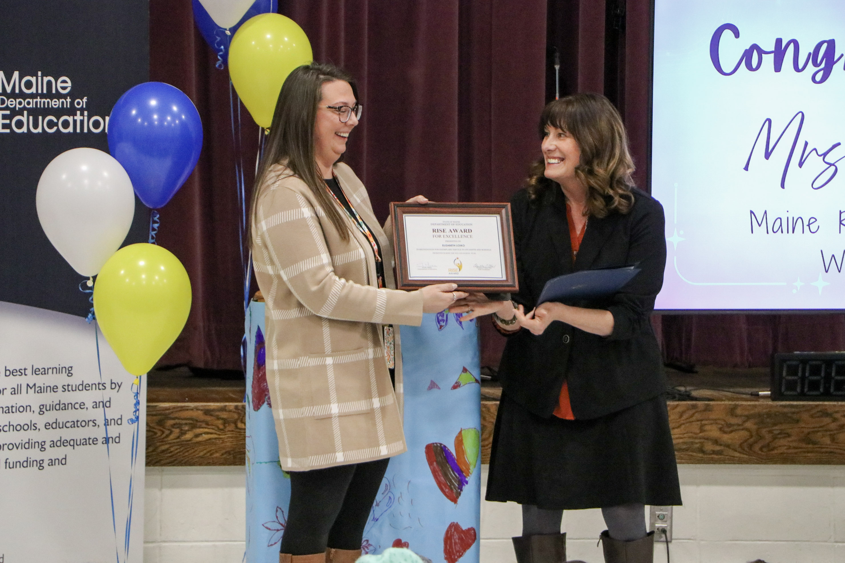 Educational technician Elizabeth Loiko accepts a 2026 RISE Award certificate from Maine DOE Commissioner Pender Makin. (Credit: Maine Department of Education)