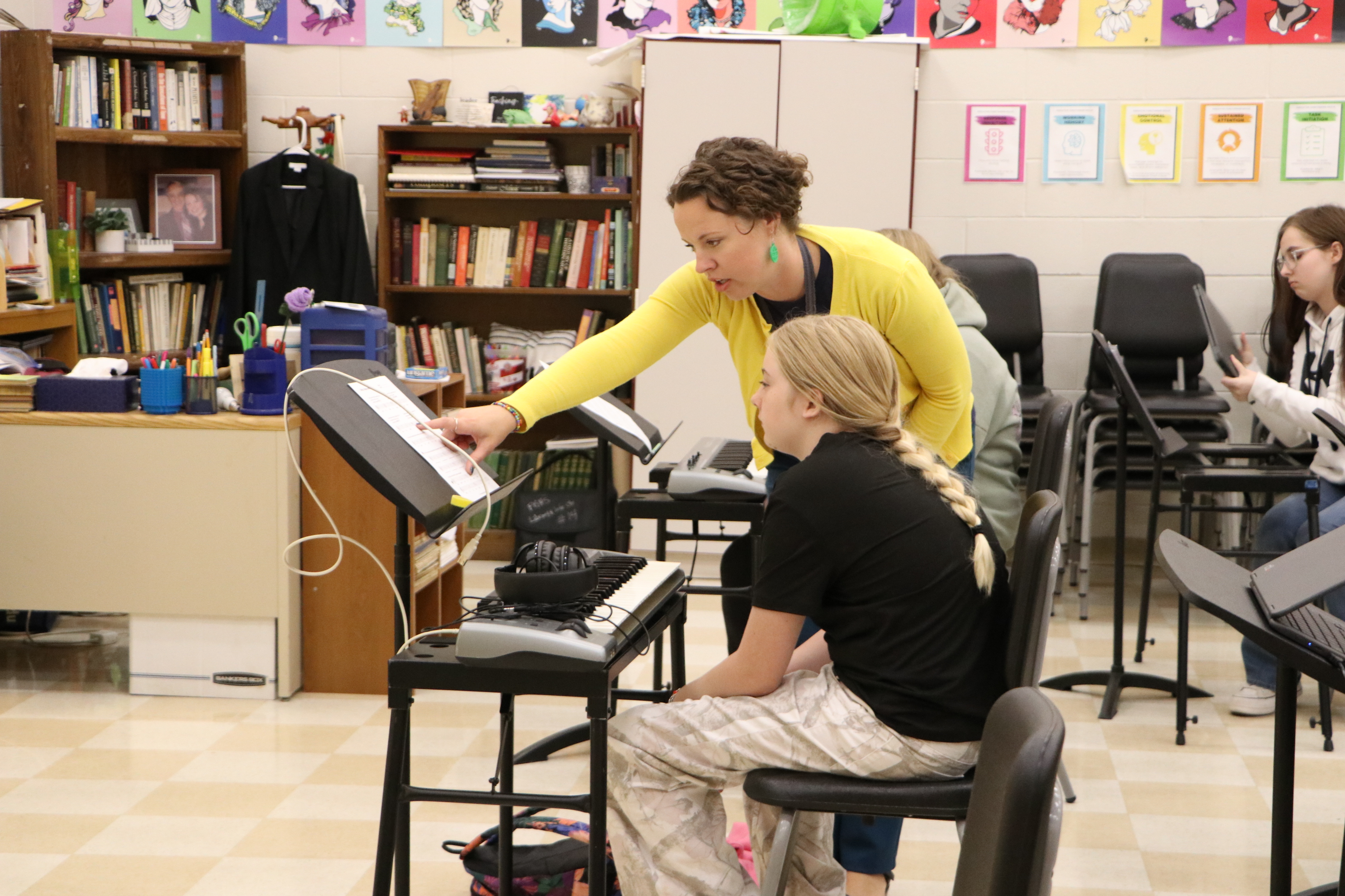 Julia in her classroom working with a student