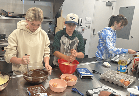 Dirigo Program students make mini cupcakes for an open house to welcome RSU 24 community members to learn about the new alternative education program.