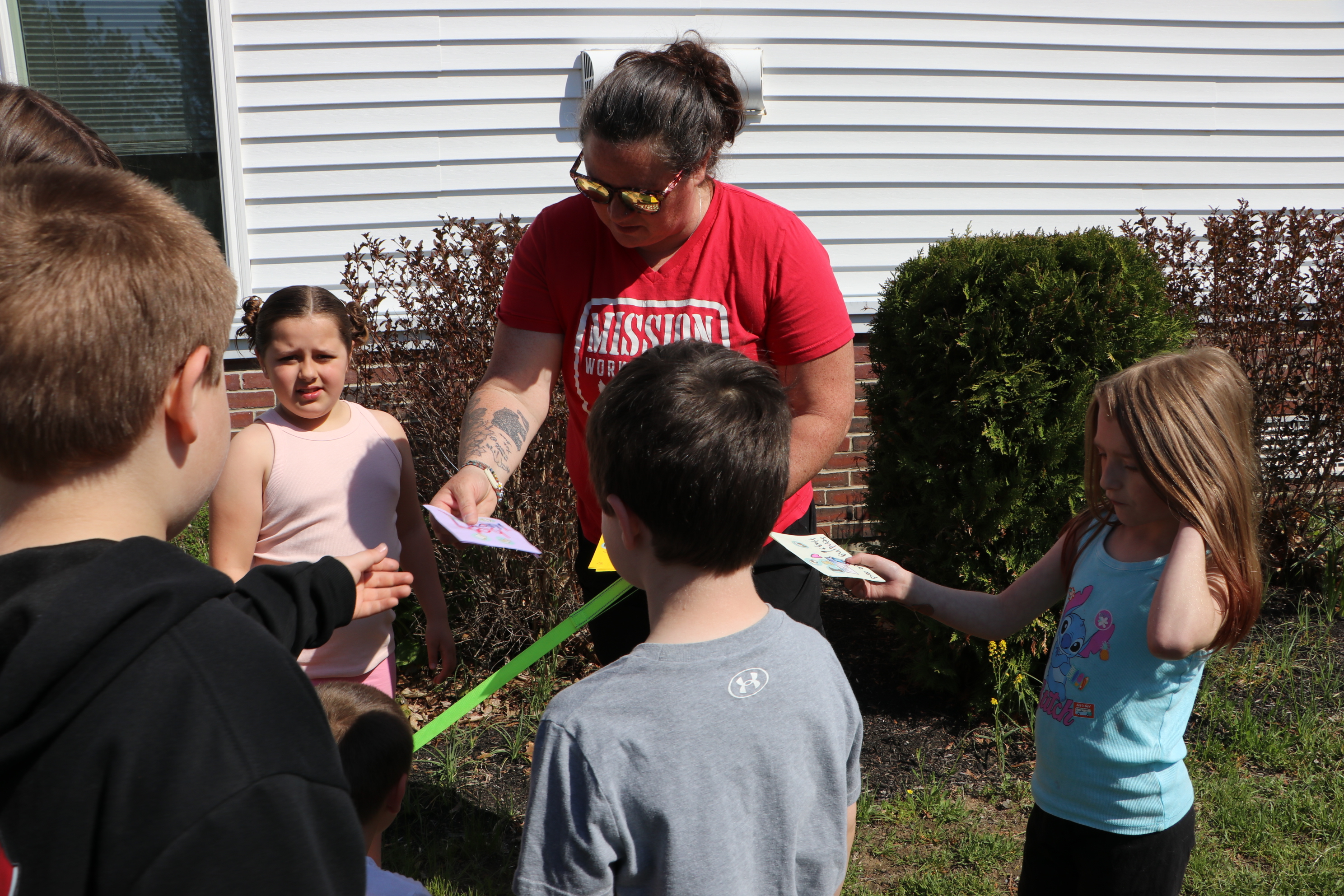 Dog handler Lauren King receives gifts of appreciation from students at Elm Street School.