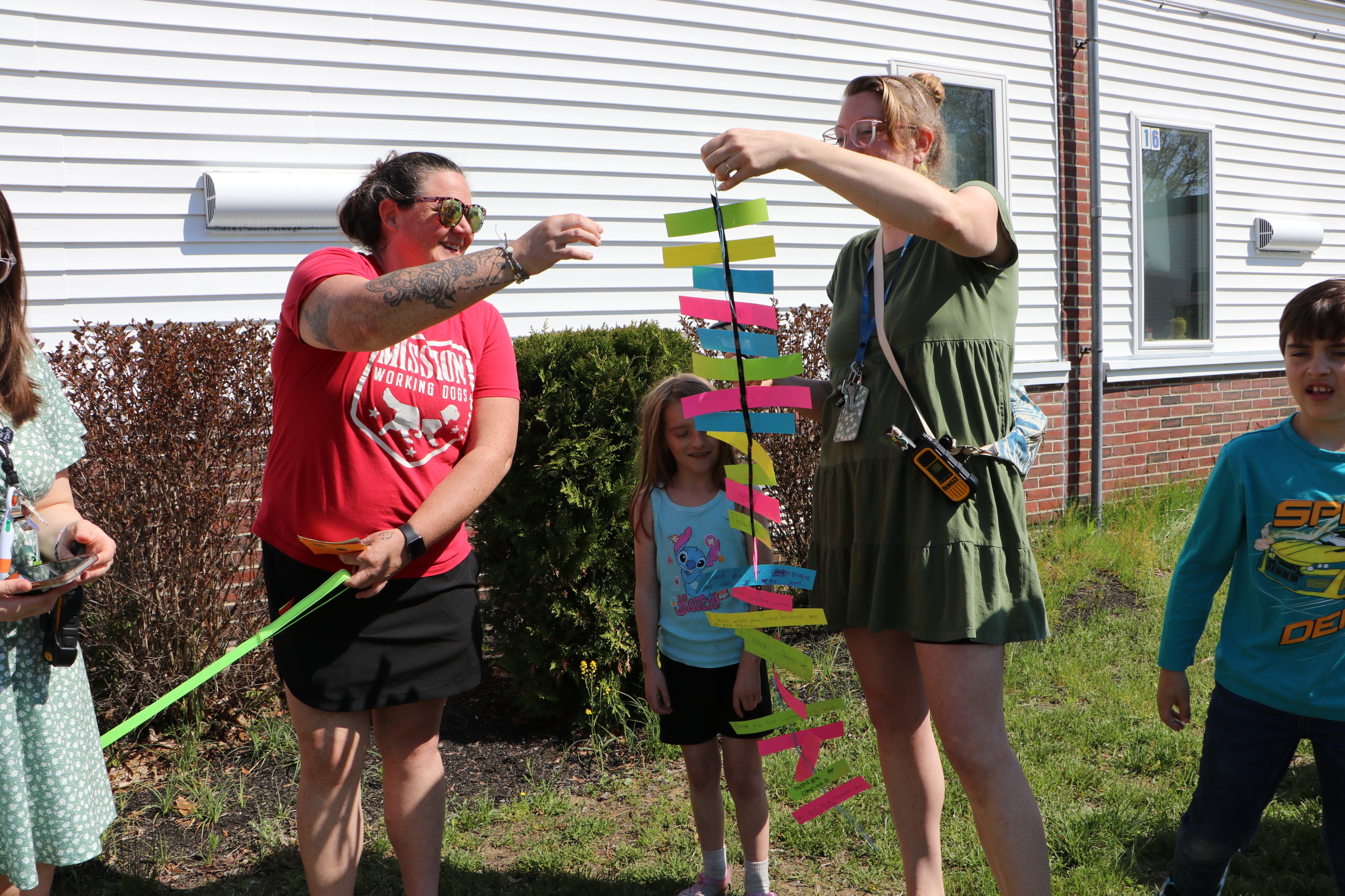 Dog handler Lauren King receives a gift of appreciation from Elm Street School Second Grade Teacher Sophia Stone.