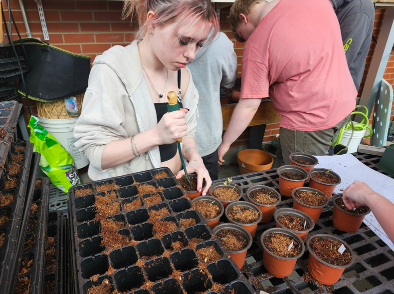 An ALP student is gains hands-on experience in plant care and propagation.