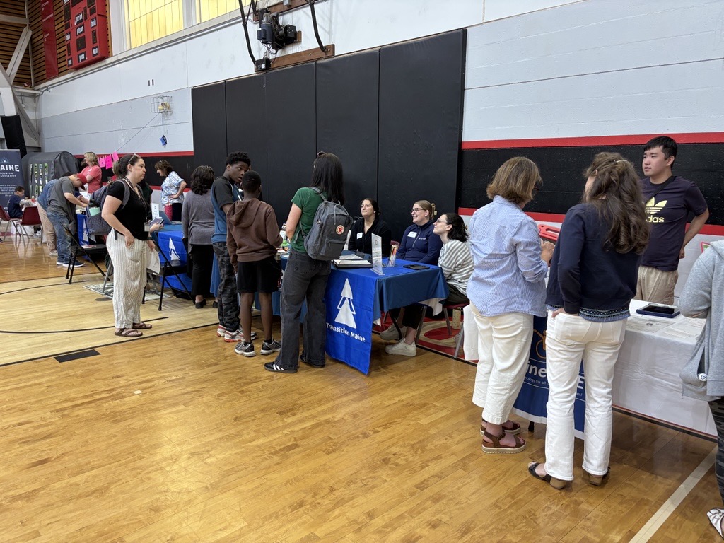 Students and summit goers talking with people at indoor table displays at the Third Annual Maine DOE ‘I Belong’ Youth Summit.