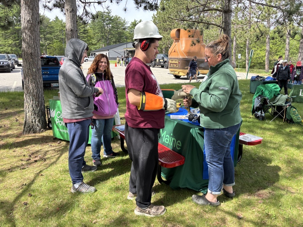 Students interacting with the Central Maine Power outdoor table display at the Third Annual Maine DOE ‘I Belong’ Youth Summit.