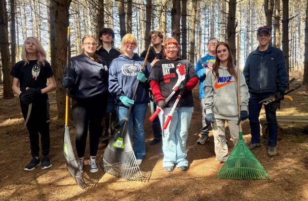 Students from Presque Isle High School’s Pathways Program participate in a spring cleanup at Mantle Lake Park in Presque Isle.