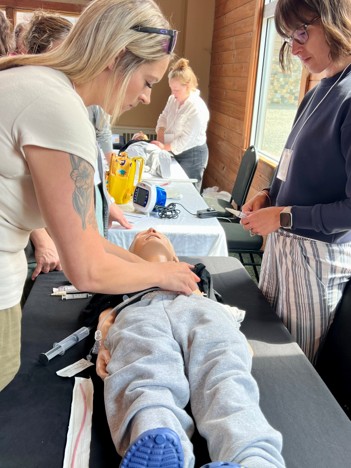 Nurses practicing skills in caring for students with gastrostomy tubes using manikins