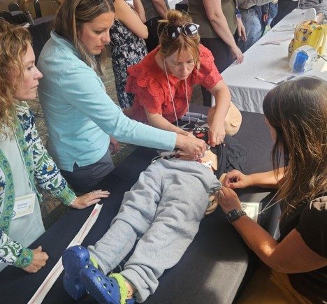 Nurses practicing skills in caring for students with gastrostomy tubes using manikins