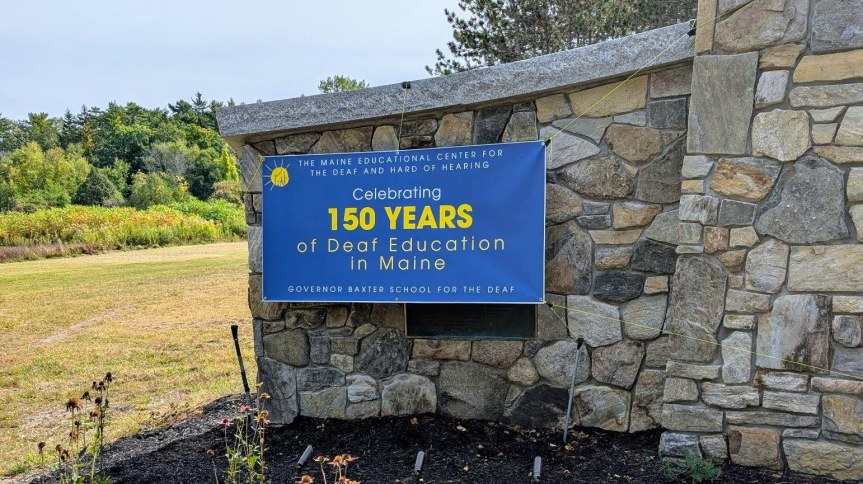 A sign out front of the school that says 150 years of Deaf Education in Maine.