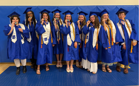 Erskine Academy Seal of Biliteracy recipients celebrate in their graduation regalia.