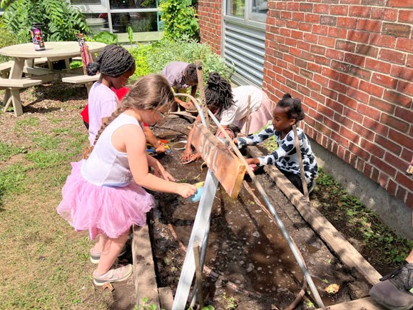 Young students doing activities outside.
